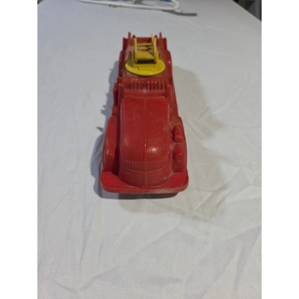 Vintage Red Plastic Fire Truck Toy with Rotating Yellow Ladder and Hose Reel